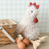 Plush chicken toy with a basket and eggs on a wooden surface