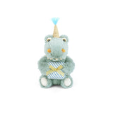 Plush toy bear with a unicorn horn and party hat on a white background